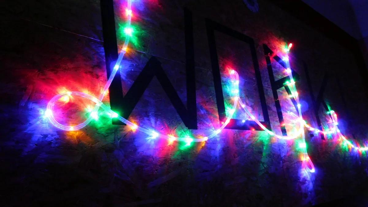 Bright neon signs glowing against a dark night wall, the hum of a game room.