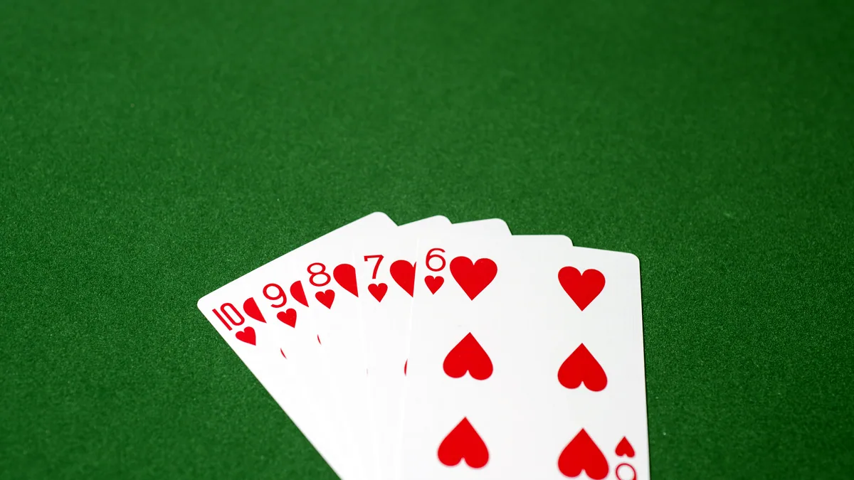 Playing cards spread out on a green felt surface, ready for a quiet solitaire hand.